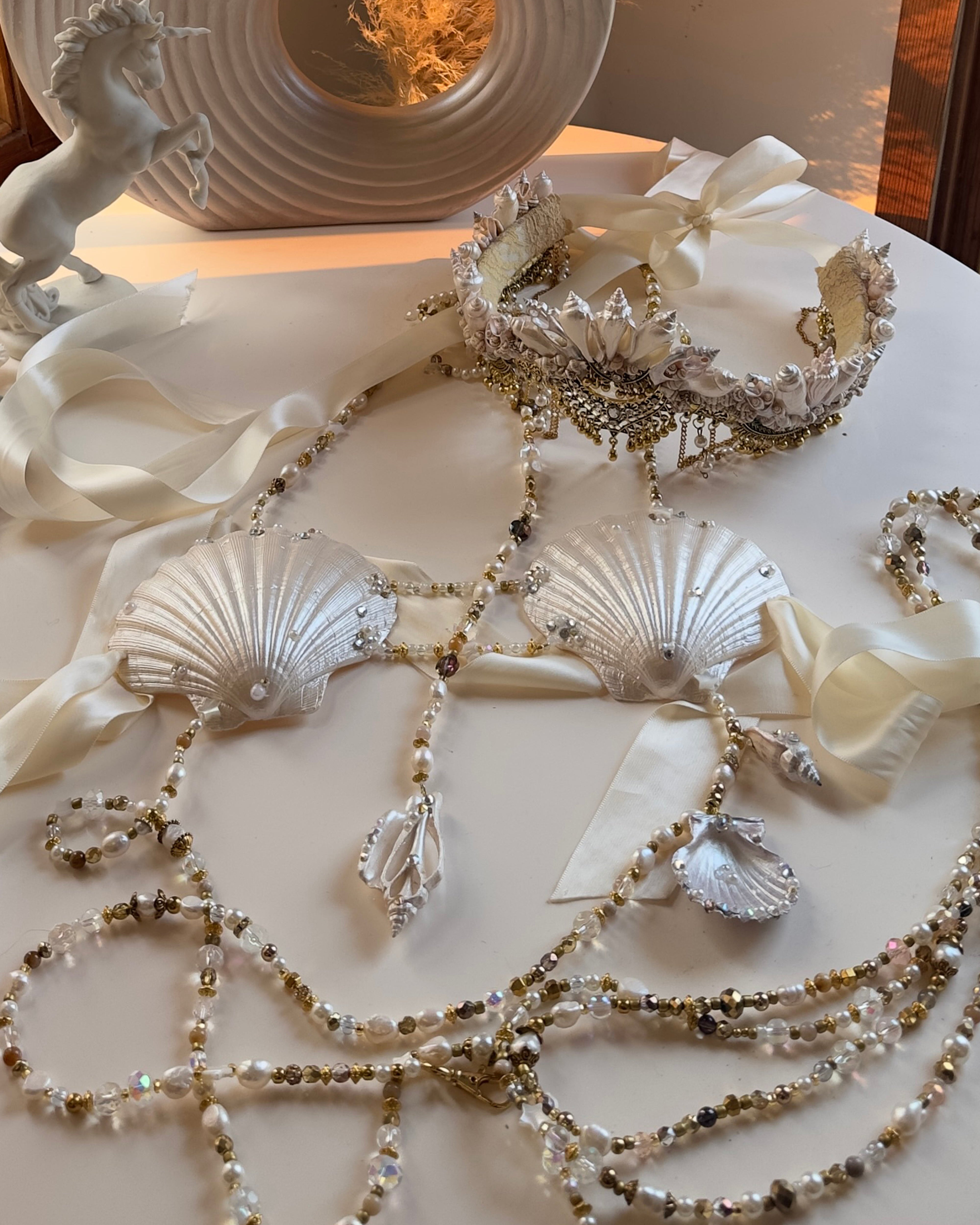 Decorative necklace with shell and bead details on a white surface